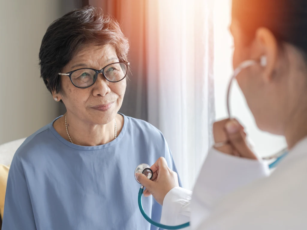 Doctor checking a patient's heart health with a stethoscope