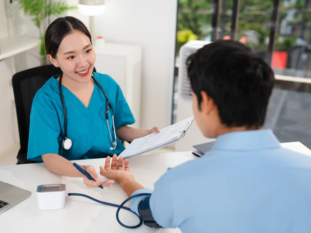 Doctor discussing tumour marker test results with a patient during a health screening consultation